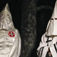 Two members of the Ku Klux Klan photographed in Pelham, North Carolina on December 2, 2016. Image via AP Photo.